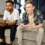Two friends sitting on a sofa, playing video games together at home. — Direct Big Provider Slot Websites – Understanding Plat